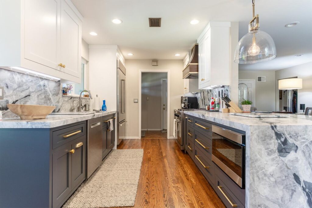 Whole home remodel San Francisco kitchen featuring quartzite countertops, two-tone white cabinetry, and warm wood accents