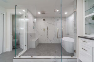 Walk in shower remodel in Los Gatos with frameless glass enclosure, marble tile walls, and modern fixtures