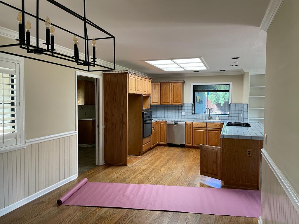 Before and after home kitchen in San Jose showing original oak cabinets, tile countertops, and dated layout prior to Shulman Ave renovation with open concept design