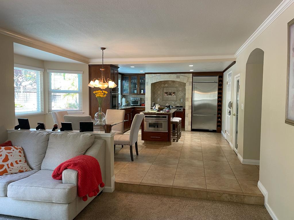 Before kitchen remodel on Crossmont Circle showing dark wood cabinetry and tile flooring prior to custom maple cabinet installation