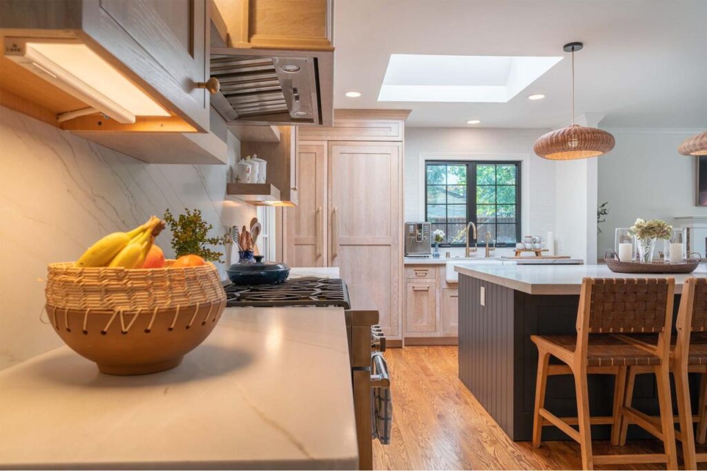 Completed project Shulman Ave home remodel showcasing open concept kitchen with skylight, custom maple cabinetry, natural quartzite countertops, and dining flow