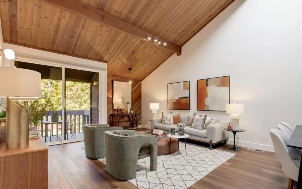Mountain View living room on Central Ave featuring wood ceiling, diagonal wood accent wall, deck access, and wide-plank floating vinyl flooring