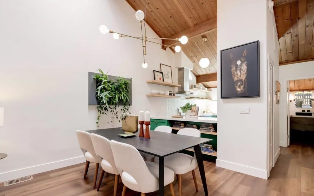 Central Ave dining area in Mountain View with wood ceiling, exposed beams, open shelving, and custom green cabinetry in background