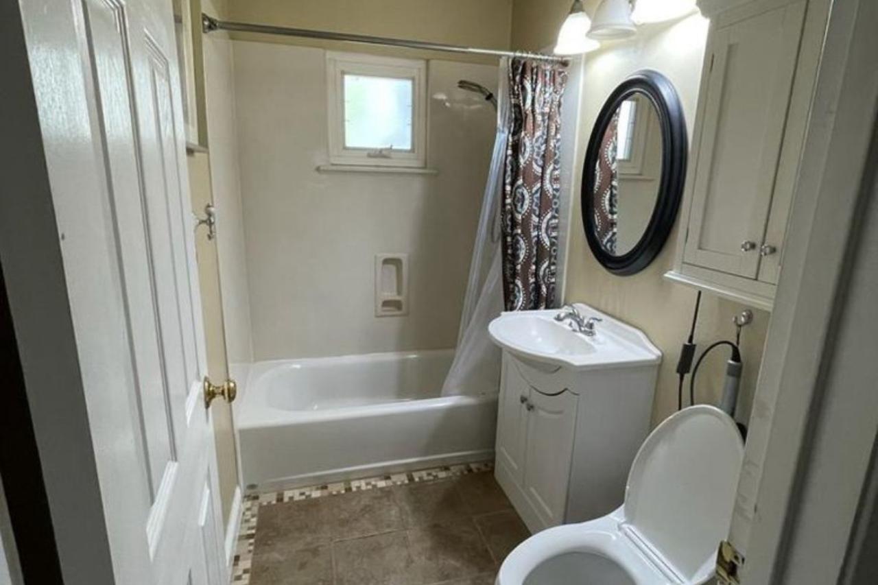 Before bathroom remodel on Bucher Ave in Santa Clara showing dated tile, pedestal vanity, and shower-tub combo prior to marble transformation