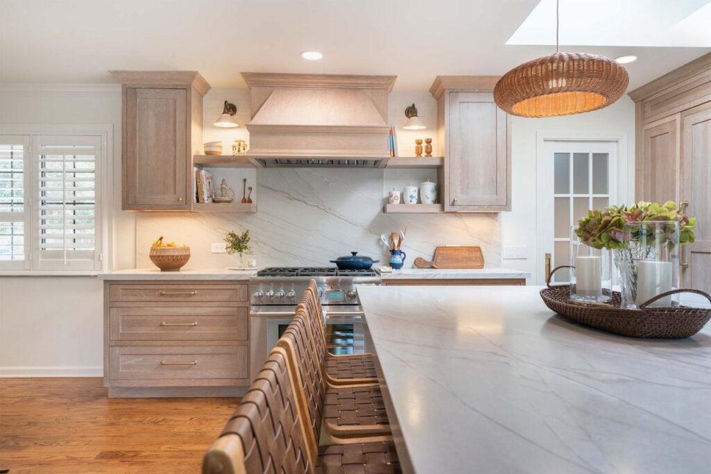 Shulman Ave home remodel kitchen featuring custom maple cabinetry, natural quartzite countertops, floating shelves, and open concept flow to dining area