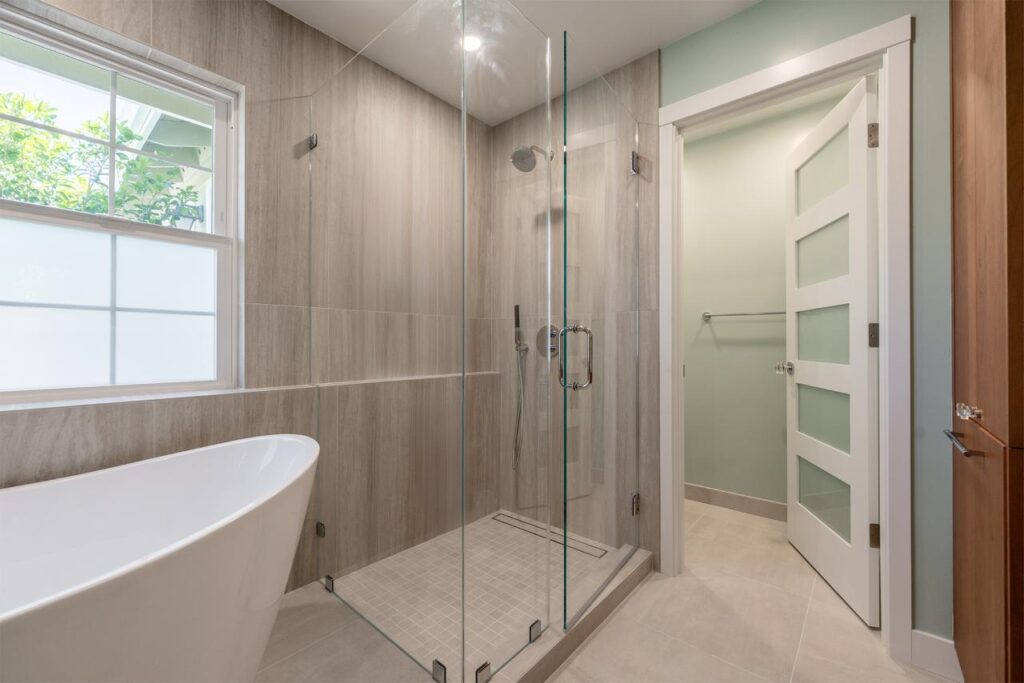 Complete master suite renovation in Monte Sereno with freestanding soaking tub, frameless walk-in shower, radiant heated tile floors, and natural light-filled design