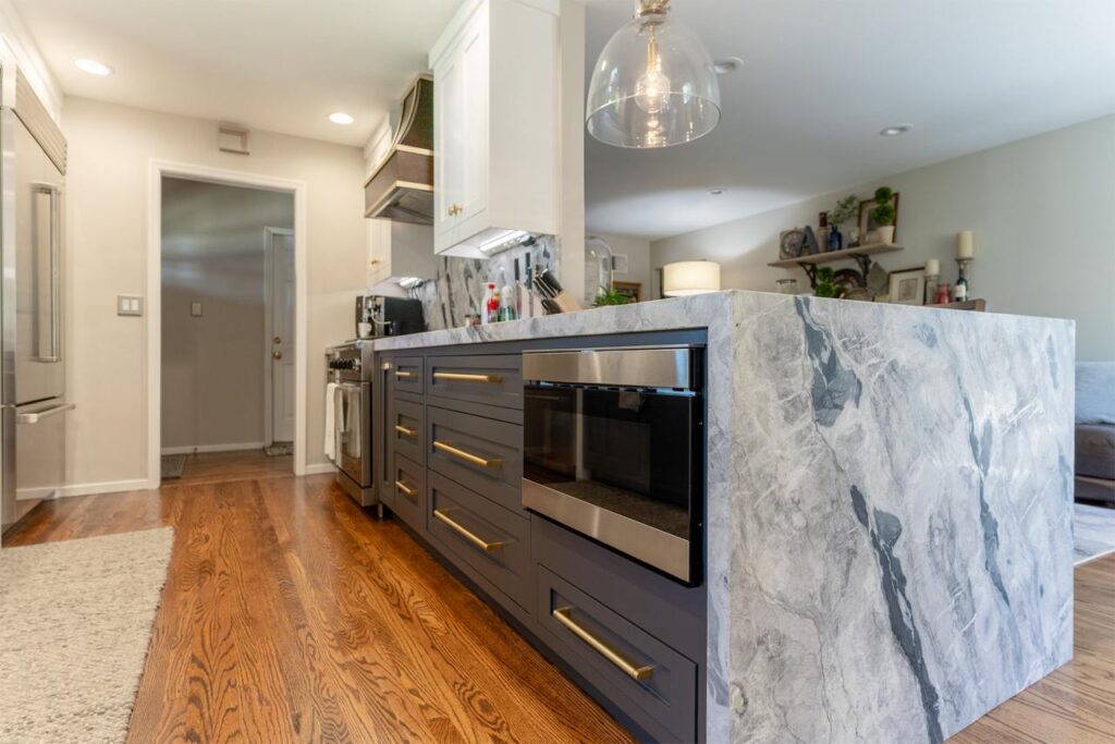 Bucher Ave kitchen in Santa Clara with mini waterfall island edge, built-in microwave drawer, bookmatched marble countertops, and custom inset cabinetry