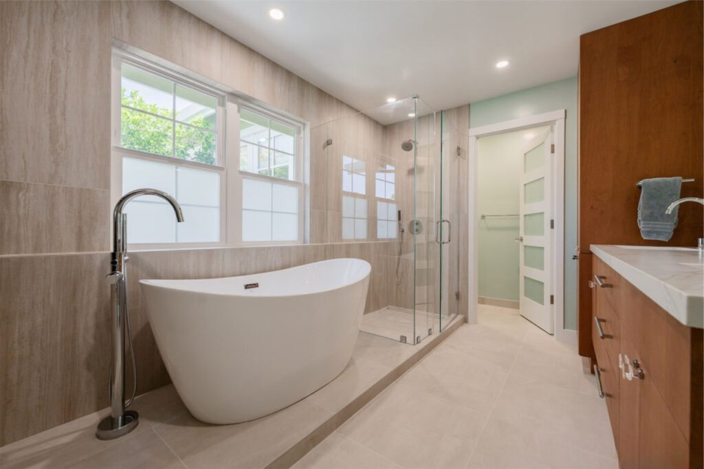 Modern bathroom design San Francisco featuring freestanding tub with frameless shower and wood accents by ASL Remodeling