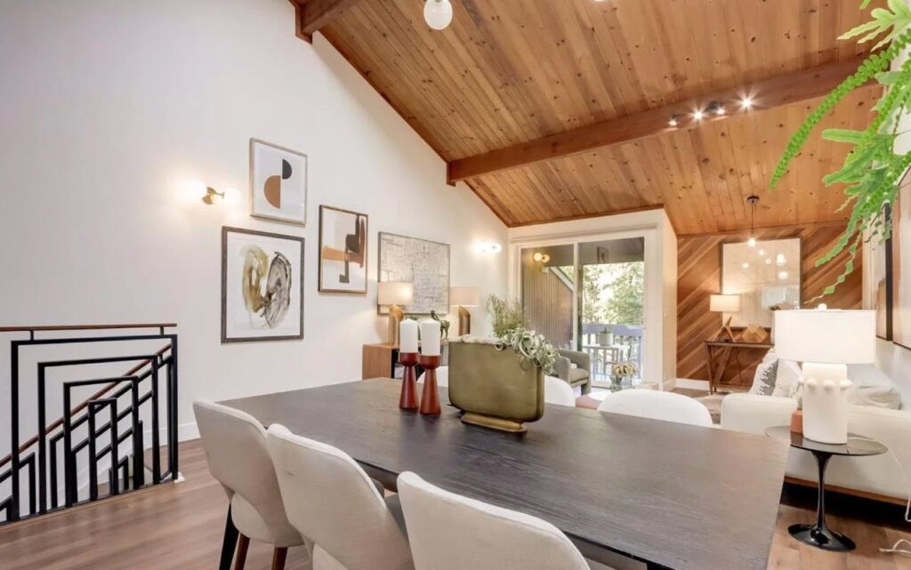 Mountain View dining area on Central Ave with wood ceiling, exposed beams, modern metal stair railing, and diagonal wood accent wall