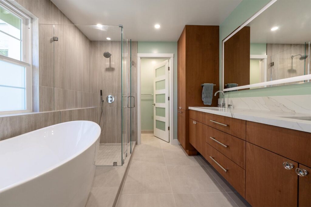 Primary bathroom in Los Gatos showcasing custom walnut cabinetry with soft-close drawers, white upper storage, and spa-level design with modern fixtures