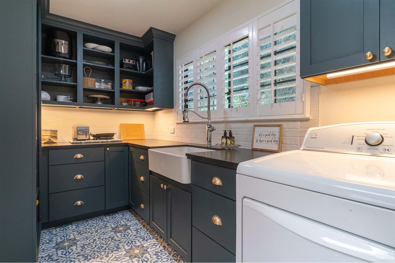 Shulman Ave home remodel laundry room with custom dark cabinetry, patterned tile flooring, open shelving, and layout redesign for improved workflow efficiency
