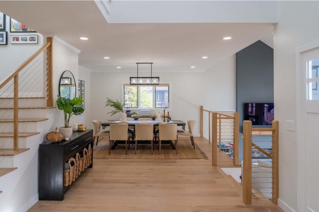 Vista Del Mar dining room in Los Gatos with vaulted ceiling, shiplap walls, modern staircase with cable railing, and engineered white oak flooring