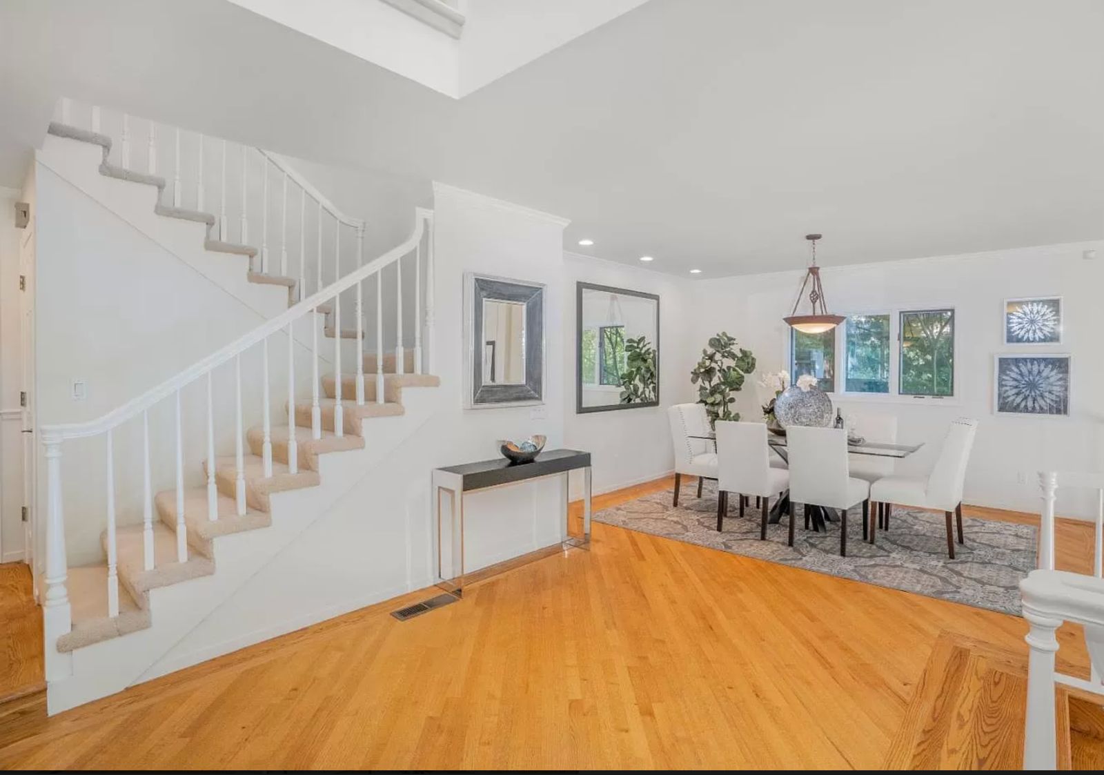 Before photo of Vista Del Mar home remodel showing original staircase and flooring prior to white oak and cable railing installation by ASL Remodeling in Los Gatos